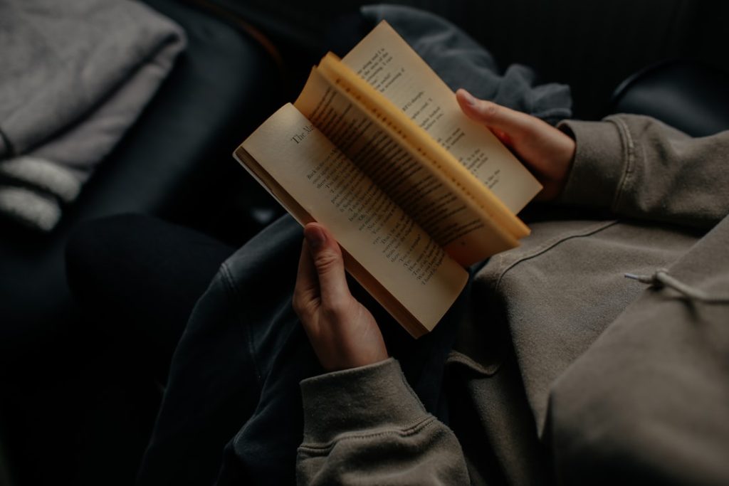 person-reading-book-white-sitting-iykvgru79g4